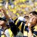 Michigan senior Lauren Blanchard, of Traverse City, holds a pretend microphone as she sings along with the crowd during the first half against Eastern Michigan at Michigan Stadium on Saturday. Melanie Maxwell I AnnArbor.com